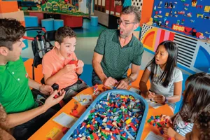 Master model builder helping children and adult build with LEGO bricks